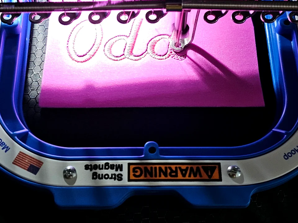 Oddo name being stitched by an embroidery machine
